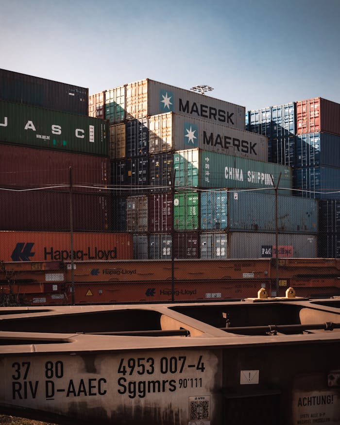 A view of colorful cargo containers stacked at a bustling industrial harbor.
